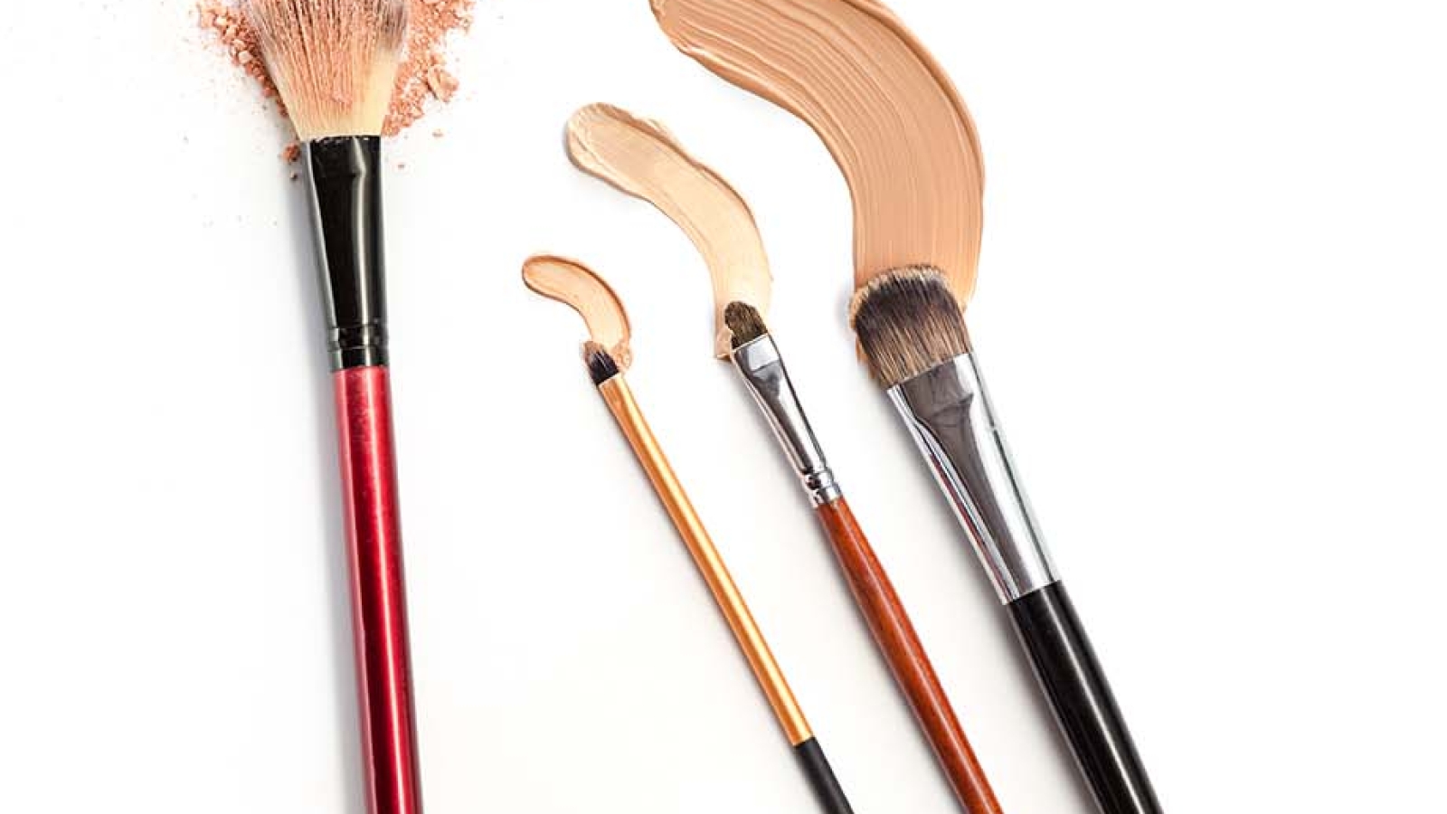 Close-up of crushed mineral shimmer powder golden color with makeup brush on white background with Cosmetic foundation cream